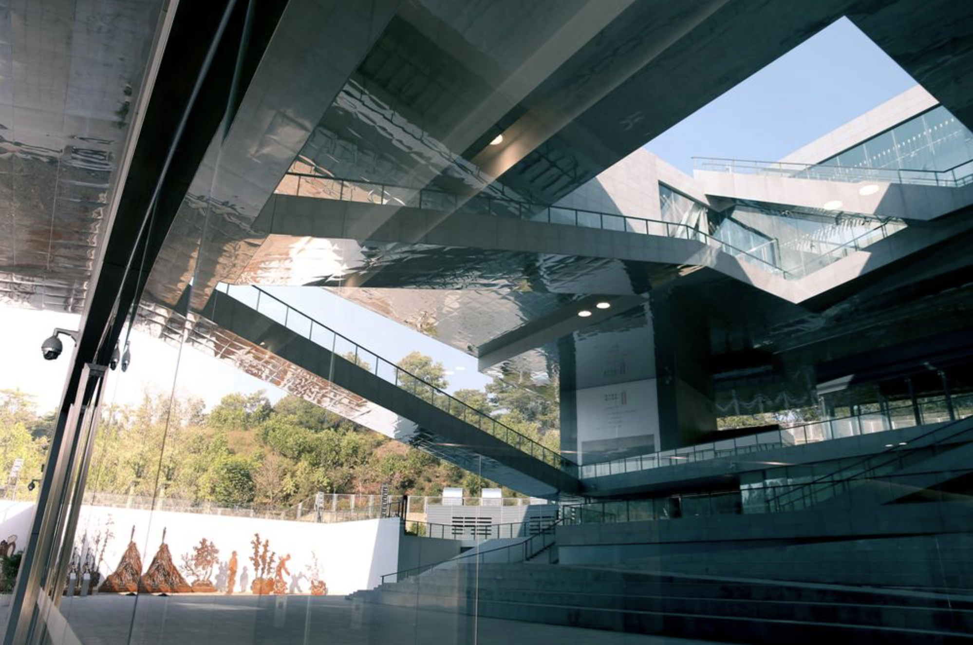 Guanlan Printmaking's building, emphasizing a moment of criss-crossing bridged walkways.